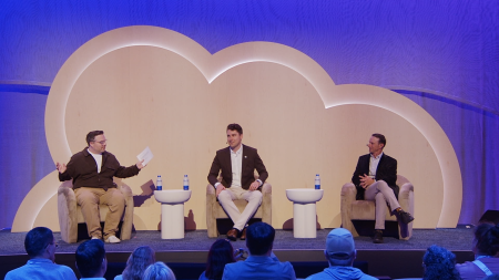 three panelists sitting on stage