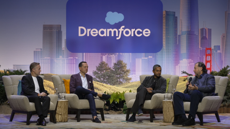 Marc Benioff and three panelists sitting in chairs on stage