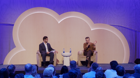 two people on stage sitting in chairs and having a conversation