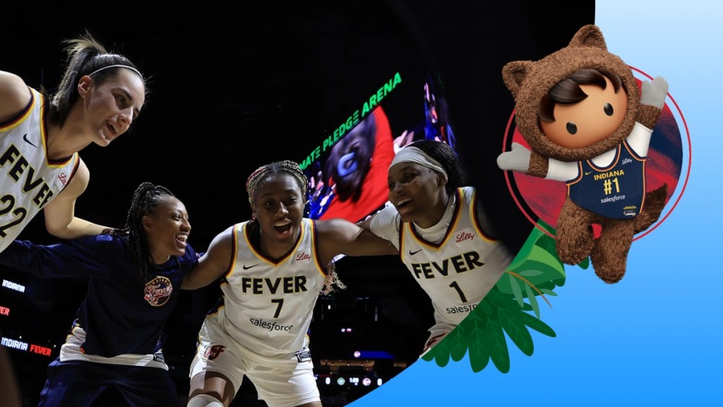 Excited Indiana Fever players embracing during a game at Climate Pledge Arena, paired with a cheerful Salesforce Astro mascot wearing a Fever #1 jersey.