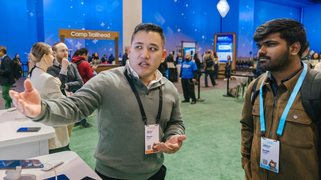 Two people talking at conference.